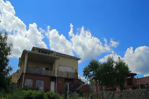 Clouds over modern house timelapse Stock Footage 26044454