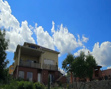 Clouds over modern house timelapse Stock Footage 26045108