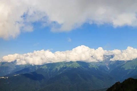 Clouds over the mountain ridge. Time Lapse. Krasnaya Polyana, Sochi, Russia. 4K+ Vídeo Stock 53611697