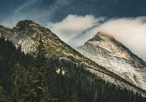 Clouds over mountain scenery with Mount Sir Donald in Glacier National Park Stock Photos