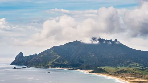 Clouds over mountain summit in Ocean Beach Coast in New Zealand landscape Stock Footage 145023906