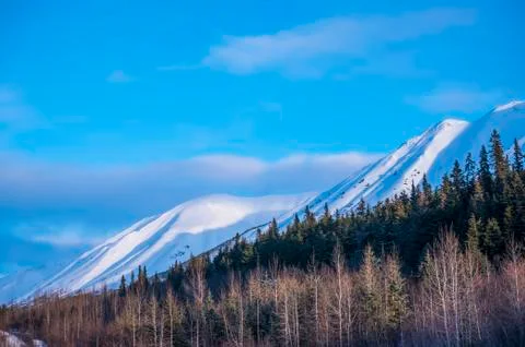 Clouds over mountain tops as daylight fades on the Chugach Mountains in South-ce Stock Photos