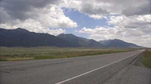 Clouds over Mountains and an Empty Road Stock Footage 46773861