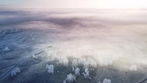Clouds over the mountains and forest at foggy sunrise. Aerial view. Stock Footage 255635942