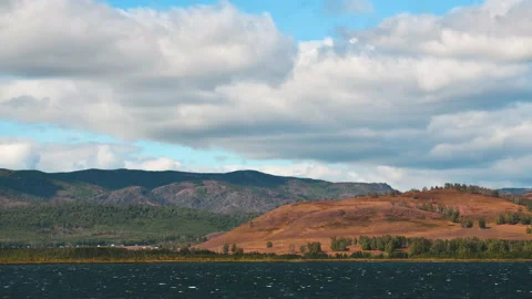 Clouds over the mountains and lake timelapse Stock Footage 161303560