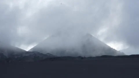 Clouds over the mountains with dark sand Stock Footage 258313802