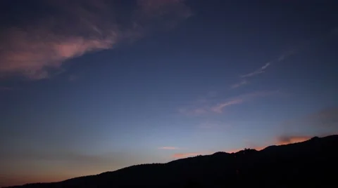 Clouds over the mountains in the evening and becomes dark Stock Footage 47726685