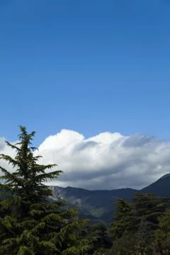 Clouds over mountains Stock Photos