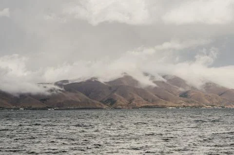 Clouds over the mountains on the shore. Photos