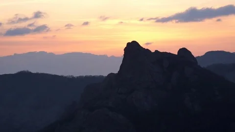 Clouds over mountains at sunset. Timelapse Stock Footage