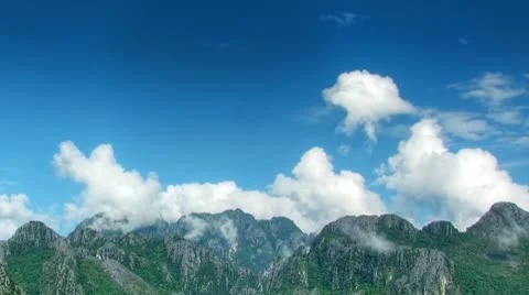 Clouds over mountains time lapse Stock Footage 8987645