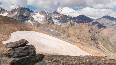 Clouds over the mountains valley with snow Stock Footage 171528257