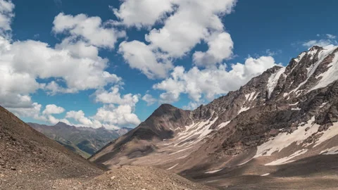Clouds over the mountains valley with snow 動画素材 171855532