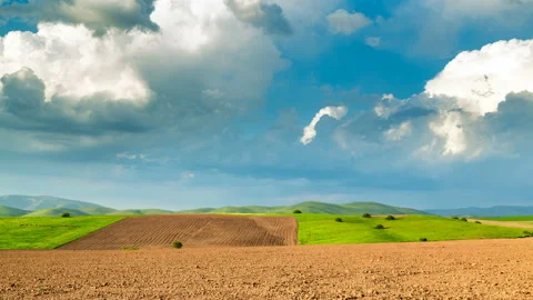 Clouds over plowed fields. Spring in sunny weather. Stock Footage 108105622