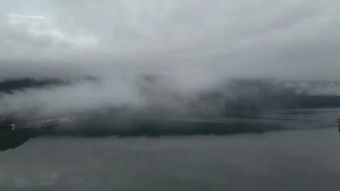 The clouds over a pristine lake surrounded by the mountains. Stock Footage 247869270