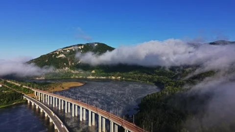 Clouds over the river and hills near a bridge during daylight Stock Footage 339648315