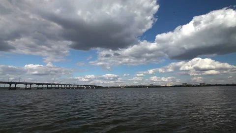 Clouds over the river. Beautiful clouds over the bridge across the river Stock Footage 139440568