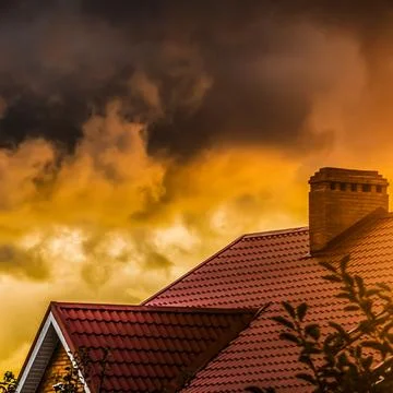 Clouds over the roof Stock Photos