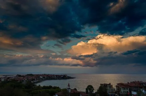 Clouds over the sea at sunset Stock Photos