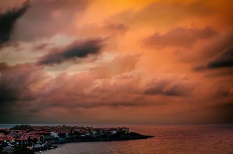 Clouds over the sea at sunset Stock Photos