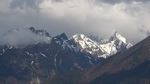 Clouds over snow-capped mountain peaks Stock Footage 257473253
