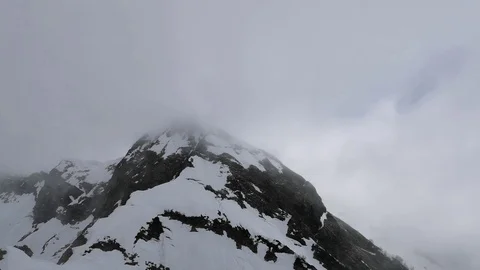 Clouds over the snow-capped mountains Stock Footage 109338126