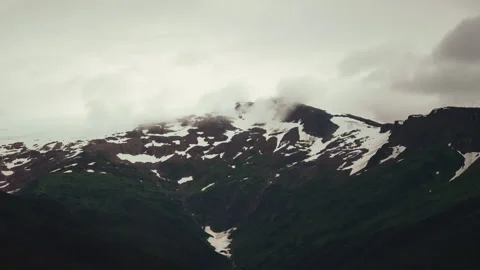 Clouds over a snow patched mountain peak in Alaska Stock-Footage 347816752