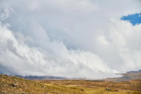 Clouds over the steppe open spaces, storm clouds over the hills. The Ukok Pla Stock Photos