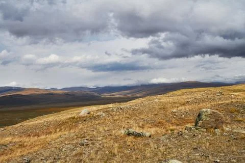 Clouds over the steppe open spaces, storm clouds over the hills. The Ukok Pla Stock Photos
