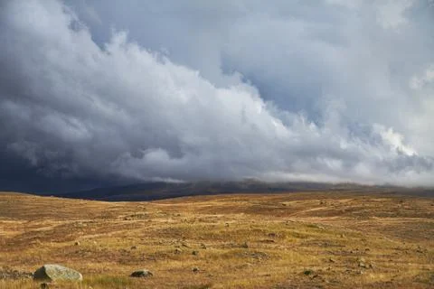 Clouds over the steppe open spaces, storm clouds over the hills. The Ukok Pla Stock Photos