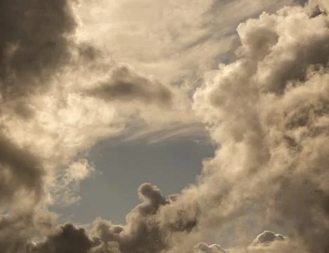 Clouds over the stormy sunset sky background Stock Photos