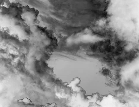 Clouds over the stormy sunset sky background 写真素材