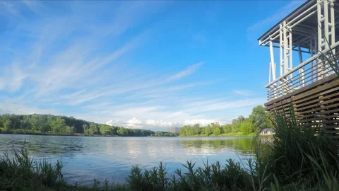 Clouds over a summer park with pond timelapse Stock Footage 77285442