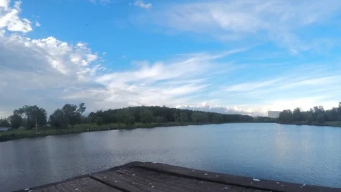 Clouds over a summer park with a pond timelapse Stock Footage 77285552