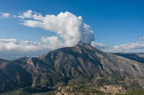 Clouds over top of Sierra de Bernia mountains range, near Benidorm, Spain Stock Photos