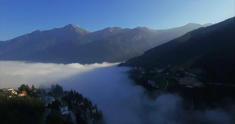 Clouds over a town in the Alps valley. Stock Footage 104708343