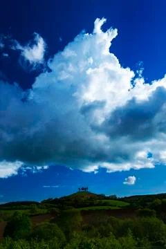 Clouds over tree topped Colmer's Hill, Dorset Stock Photos