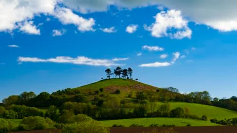 Clouds over tree topped Colmer's Hill, Dorset Stock Photos