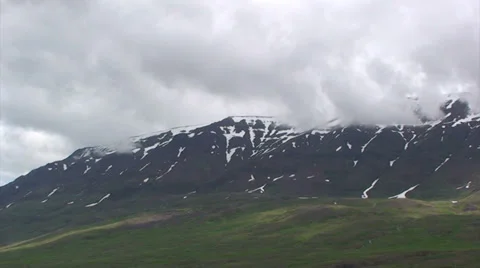 Clouds over treeless slope with snow patches Stock Footage 37319277
