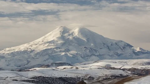 Clouds over volcano Mount Elbrus in the autumn at sunset Stock Footage 70300292