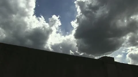 Clouds over a wall time laps Stock Footage 10902617