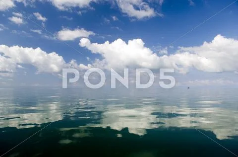 Clouds over water Stock Photos