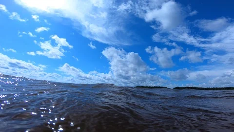 Clouds over water. The waves of the river in the summer. Video stock 100663932