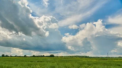 Clouds over a wheat field during sunset. Agribusiness in an ecologically clea Stock Photos