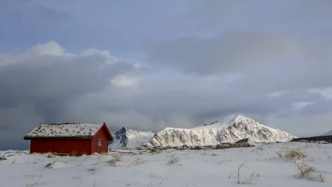 Clouds over the Winter Mountains and a Grass Roof. Time Lapse Stock Footage 106454322