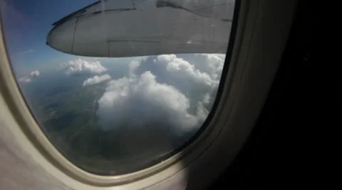 Clouds pass in an airplane riders view Stock Footage 8960156