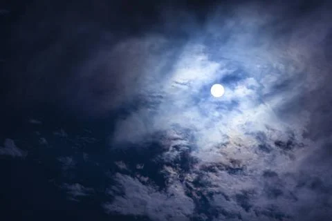  Clouds pass in front of the moon in a night sky Moon cloud and sky 2 Copy... Stock Photos