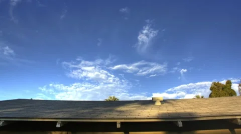 Clouds Pass Over Rooftop Timelapse Stock Footage 65052678