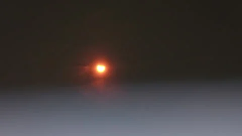 Clouds pass by the sun during solar eclipse Stock Footage 253343825