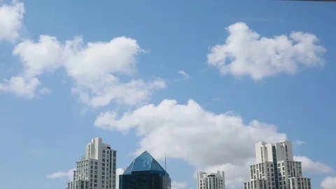 Clouds passing above modern plaza residence buildings Stock Footage 100604464